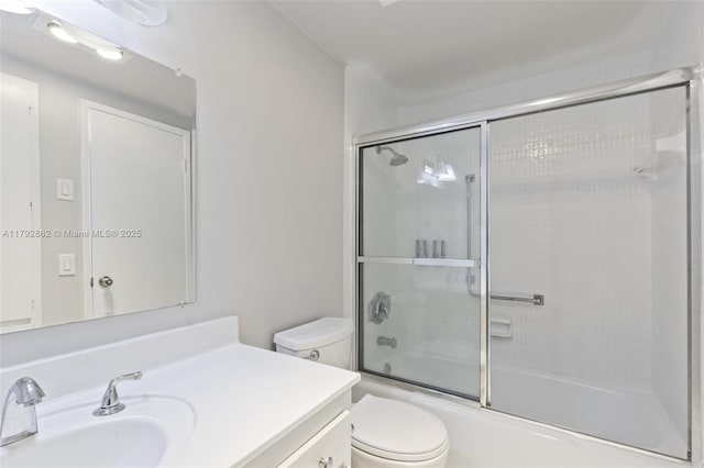full bath featuring vanity, shower / bath combination with glass door, and toilet