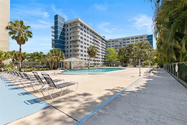 community pool featuring a patio and fence