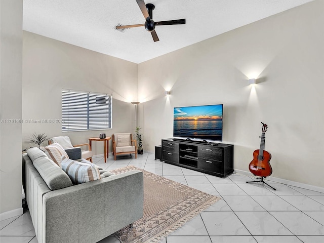 living room featuring baseboards and ceiling fan
