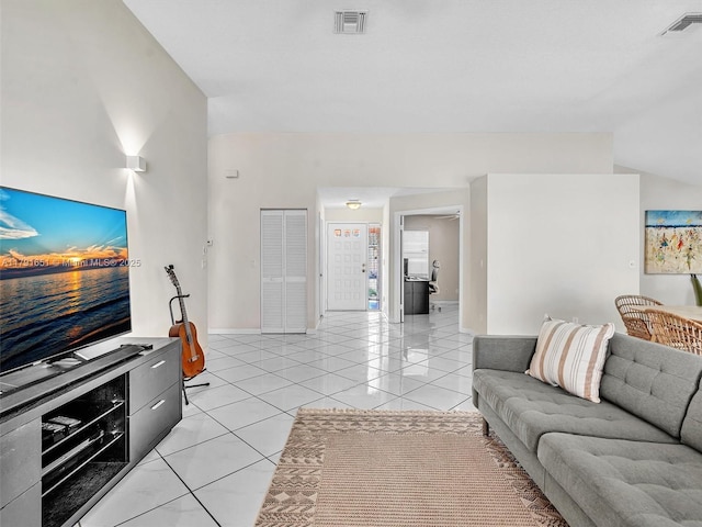 living area with light tile patterned floors, baseboards, and visible vents