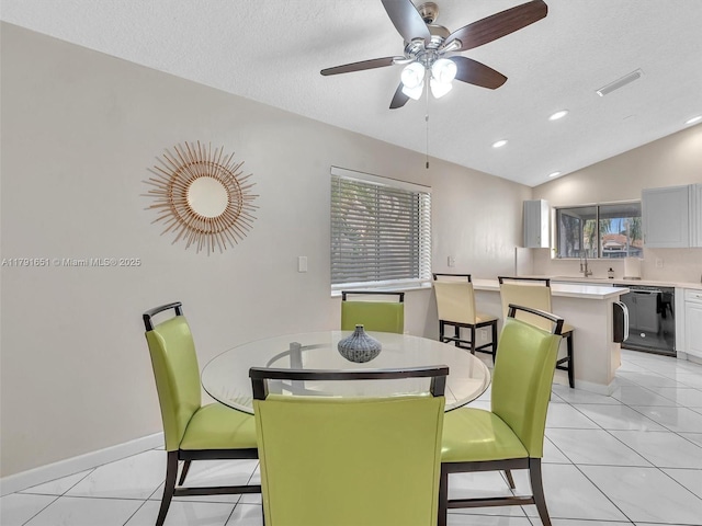 dining room with plenty of natural light, light tile patterned flooring, ceiling fan, and lofted ceiling