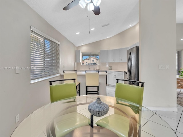 dining room with ceiling fan, recessed lighting, light tile patterned flooring, and lofted ceiling