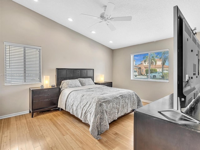 bedroom featuring lofted ceiling, baseboards, recessed lighting, a ceiling fan, and light wood finished floors