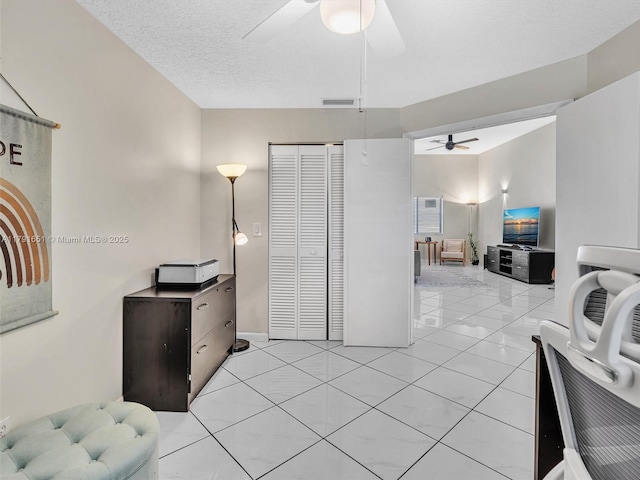 interior space featuring visible vents, ceiling fan, and light tile patterned floors