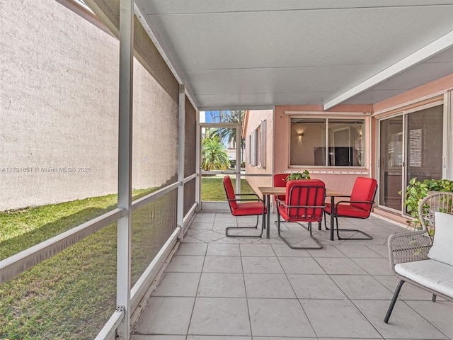 sunroom featuring outdoor dining area