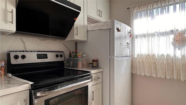 kitchen featuring light countertops, white cabinetry, and stainless steel electric range