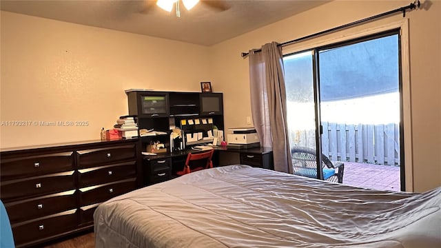 bedroom with a ceiling fan, access to exterior, and wood finished floors