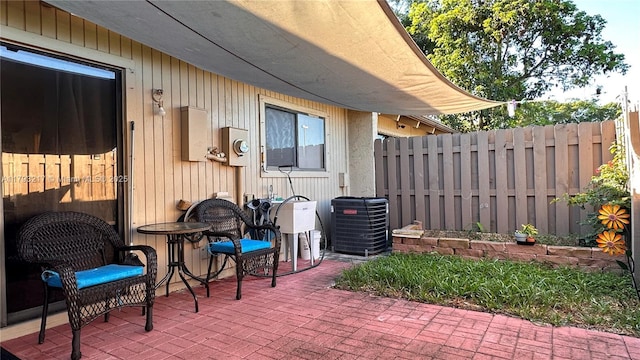 view of patio / terrace featuring fence and cooling unit