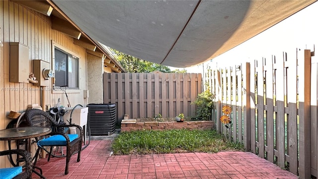 view of patio featuring fence and central AC unit
