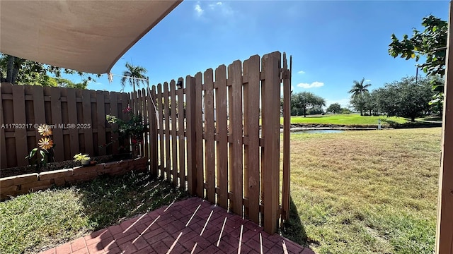 exterior space featuring a water view and fence