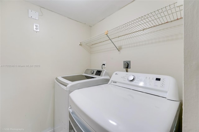 laundry area with separate washer and dryer and laundry area