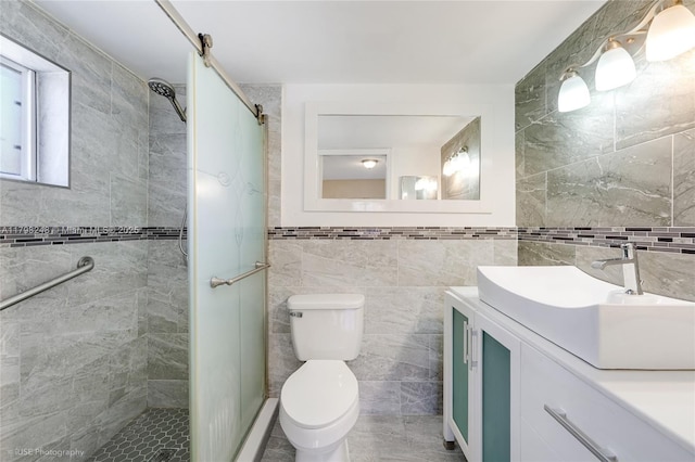 bathroom featuring vanity, toilet, tile walls, and a stall shower