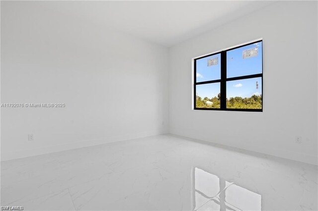 3203 Sunshine Blvd N, Lehigh Acres, FL 33971 - spare room featuring baseboards and marble finish floor
