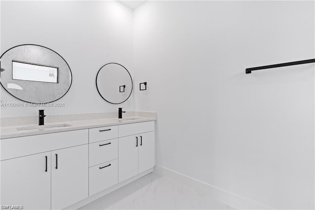 3203 Sunshine Blvd N, Lehigh Acres, FL 33971 - bathroom featuring double vanity, a sink, marble finish floor, and baseboards