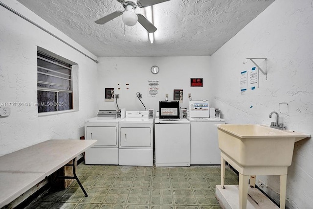 shared laundry area with a textured wall, a textured ceiling, and washer and dryer
