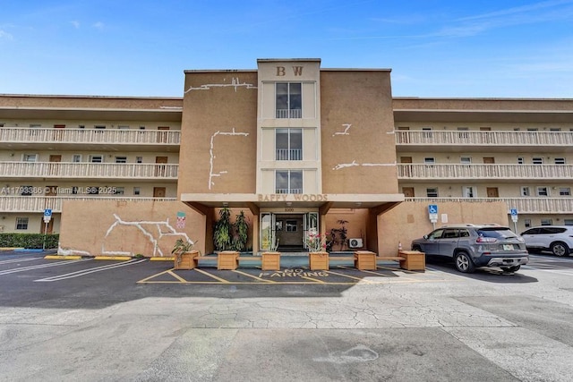 view of building exterior featuring uncovered parking