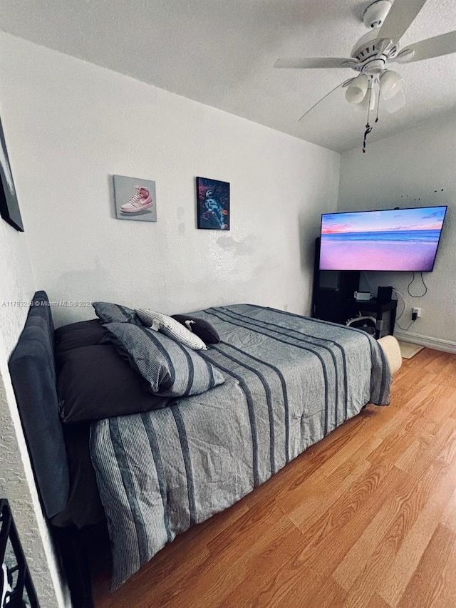 bedroom with ceiling fan and wood finished floors