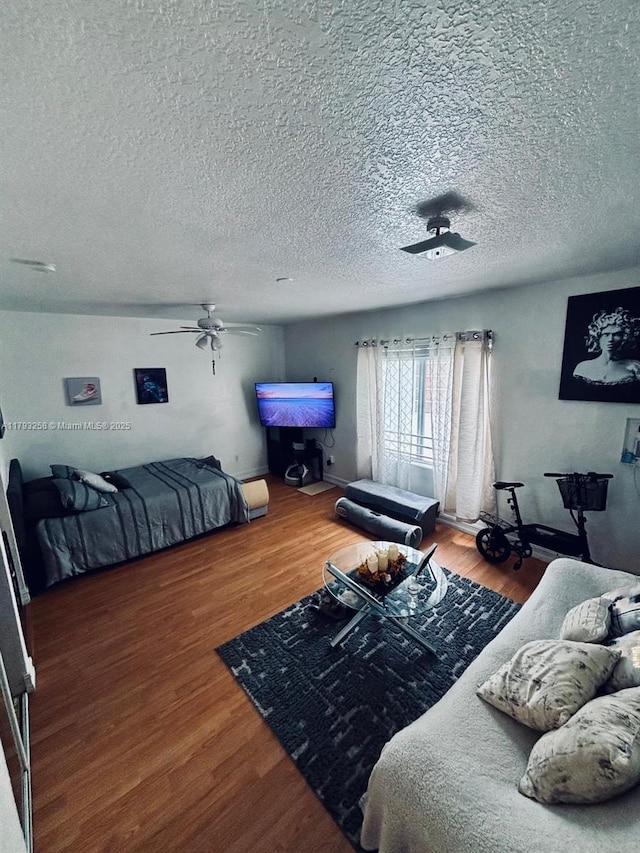 820 Euclid Ave Unit 206, Miami Beach, FL 33139 - bedroom featuring wood finished floors, a textured ceiling, and a ceiling fan