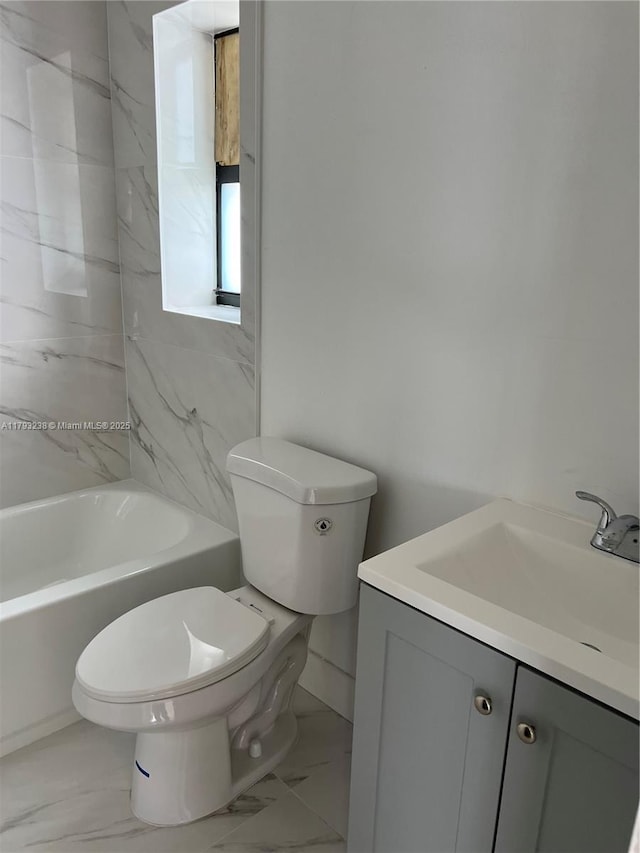 full bath with washtub / shower combination, vanity, toilet, marble finish floor, and baseboards