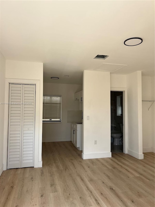 unfurnished living room with light wood-style floors and baseboards