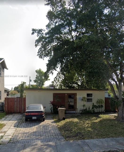 single story home with stucco siding and fence