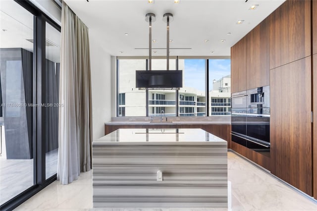17141 Collins Ave Unit 3002, Sunny Isles Beach, FL 33160 - kitchen featuring a sink, marble finish floor, floor to ceiling windows, modern cabinets, and a warming drawer