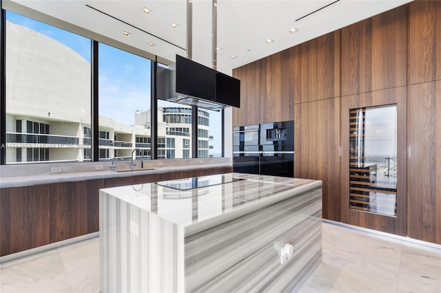 17141 Collins Ave Unit 3002, Sunny Isles Beach, FL 33160 - kitchen featuring light countertops, black electric cooktop, a sink, and modern cabinets