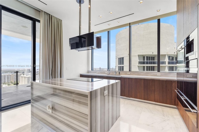 17141 Collins Ave Unit 3002, Sunny Isles Beach, FL 33160 - kitchen featuring black electric cooktop, a wall of windows, modern cabinets, and a warming drawer