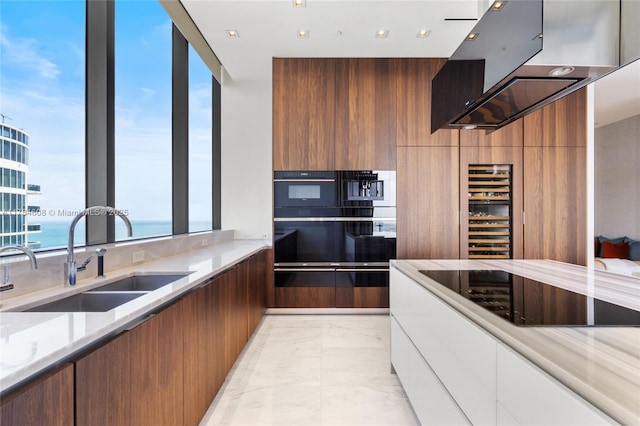 17141 Collins Ave Unit 3002, Sunny Isles Beach, FL 33160 - kitchen featuring brown cabinets, a sink, marble finish floor, wine cooler, and modern cabinets