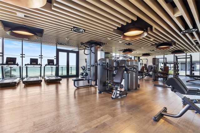 17141 Collins Ave Unit 3002, Sunny Isles Beach, FL 33160 - gym with expansive windows and hardwood / wood-style floors