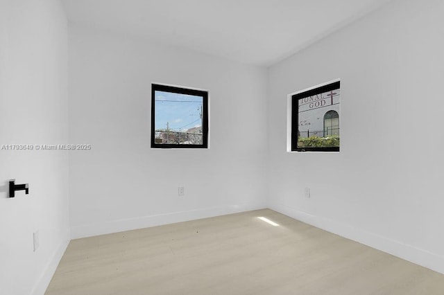 1814 NW 2nd Ct, Miami, FL 33136 - empty room with wood finished floors, healthy amount of natural light, and baseboards