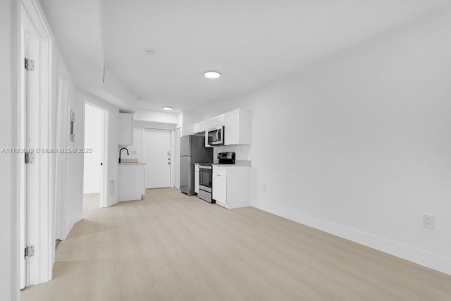 1814 NW 2nd Ct, Miami, FL 33136 - unfurnished living room featuring light wood-type flooring, recessed lighting, a sink, and baseboards