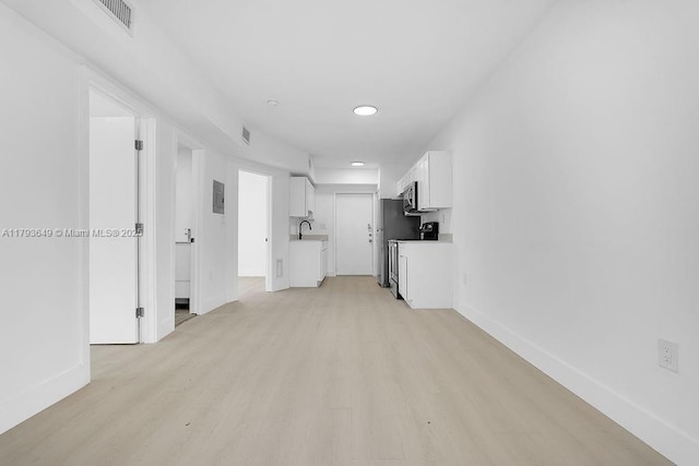 1814 NW 2nd Ct, Miami, FL 33136 - unfurnished living room featuring light wood-style flooring, baseboards, a sink, and recessed lighting