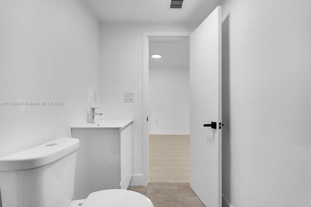 1814 NW 2nd Ct, Miami, FL 33136 - half bathroom with toilet, vanity, and wood finished floors