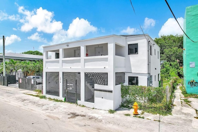 1814 NW 2nd Ct, Miami, FL 33136 - view of home's exterior featuring a balcony, stucco siding, and fence