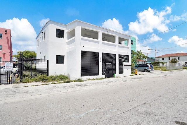 1814 NW 2nd Ct, Miami, FL 33136 - view of front of house with fence and stucco siding
