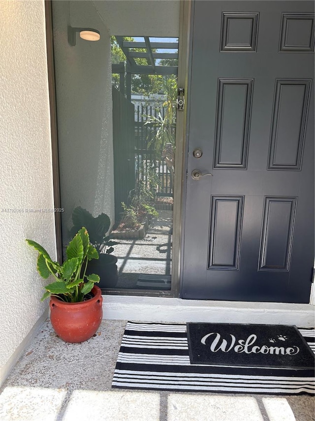 property entrance featuring stucco siding
