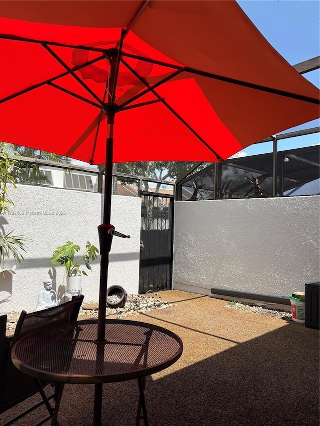 view of patio with fence and a gate