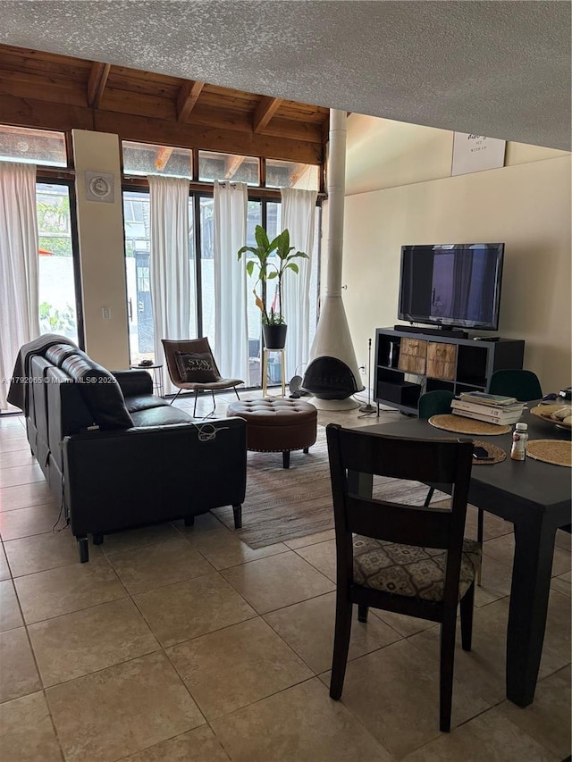 living room with beamed ceiling and tile patterned floors
