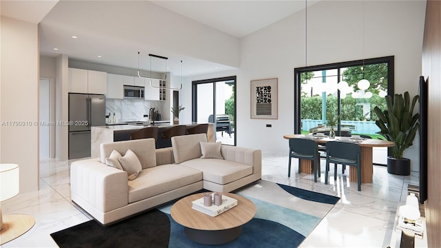 living room with a towering ceiling, recessed lighting, and marble finish floor