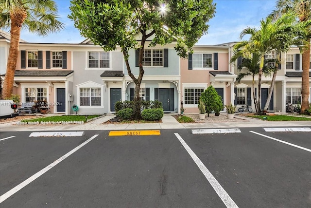 view of front of home featuring uncovered parking and stucco siding