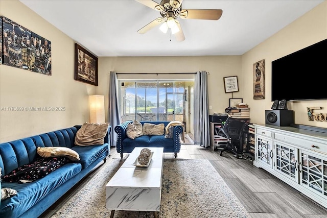 living room featuring ceiling fan and wood finished floors