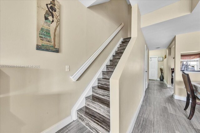 stairs featuring baseboards