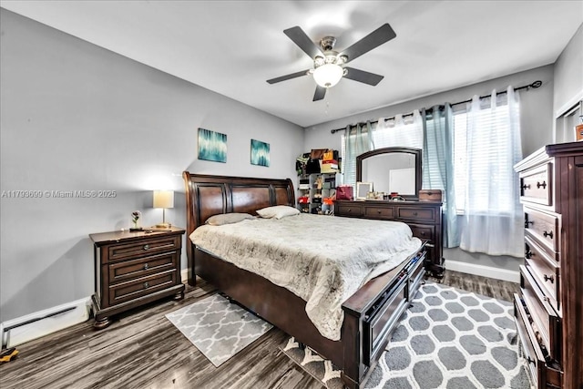 bedroom with baseboards, a baseboard radiator, dark wood finished floors, and ceiling fan