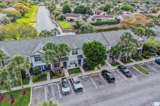 birds eye view of property featuring a water view and a residential view
