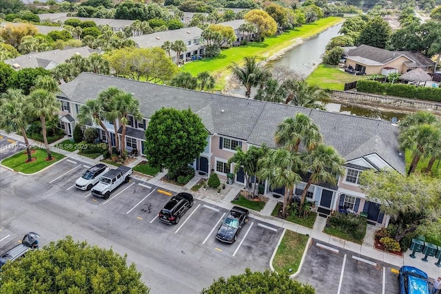 drone / aerial view featuring a residential view and a water view