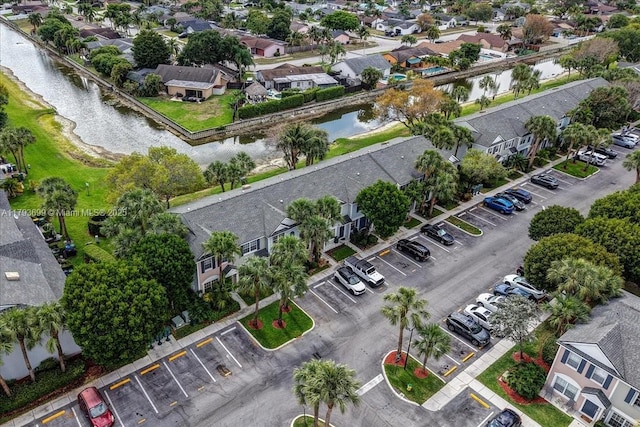 drone / aerial view with a residential view and a water view