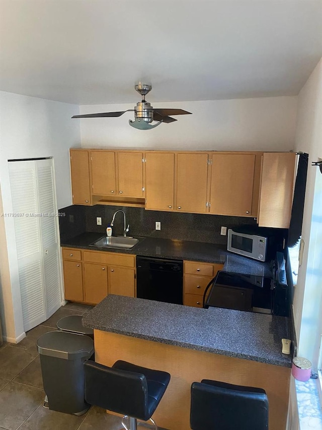 1525 Pennsylvania Ave Unit 5, Miami Beach, FL 33139 - kitchen featuring ceiling fan, a sink, stove, black dishwasher, and tasteful backsplash