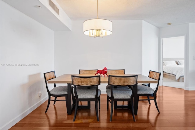19101 NE 36th Ct Unit 2509, Aventura, FL 33180 - dining room with baseboards, a notable chandelier, wood finished floors, and visible vents