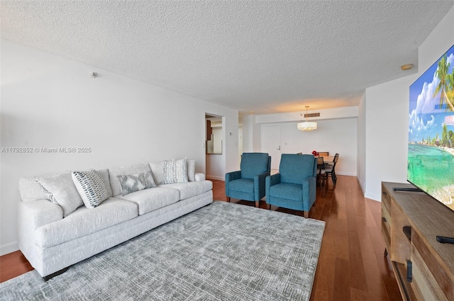 19101 NE 36th Ct Unit 2509, Aventura, FL 33180 - living area featuring visible vents, a textured ceiling, and wood finished floors